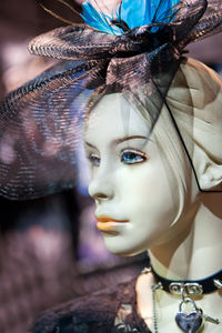 Close-up of mannequin displayed in store at night