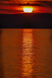 Scenic view of sea against orange sky