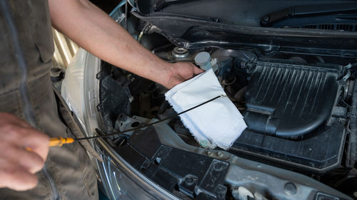 Midsection of man working on car