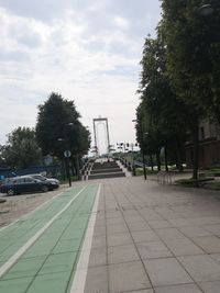 Cars on street in city against sky