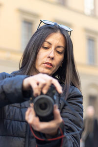 Portrait of photographer woman unfocused background at florence, italy. 50mm lens