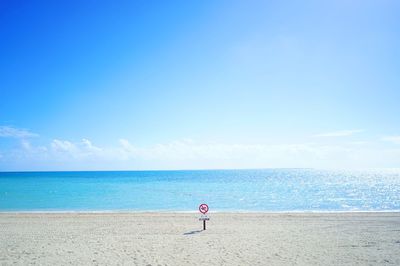 Scenic view of sea against blue sky