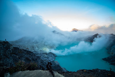 Smoke emitting from volcanic mountain against sky