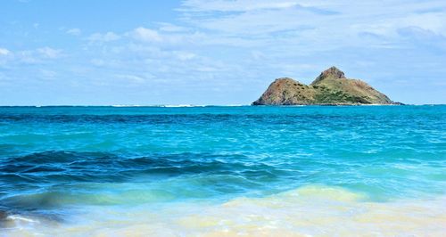 Scenic view of sea against blue sky
