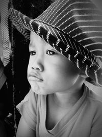 Close-up of boy wearing hat looking away