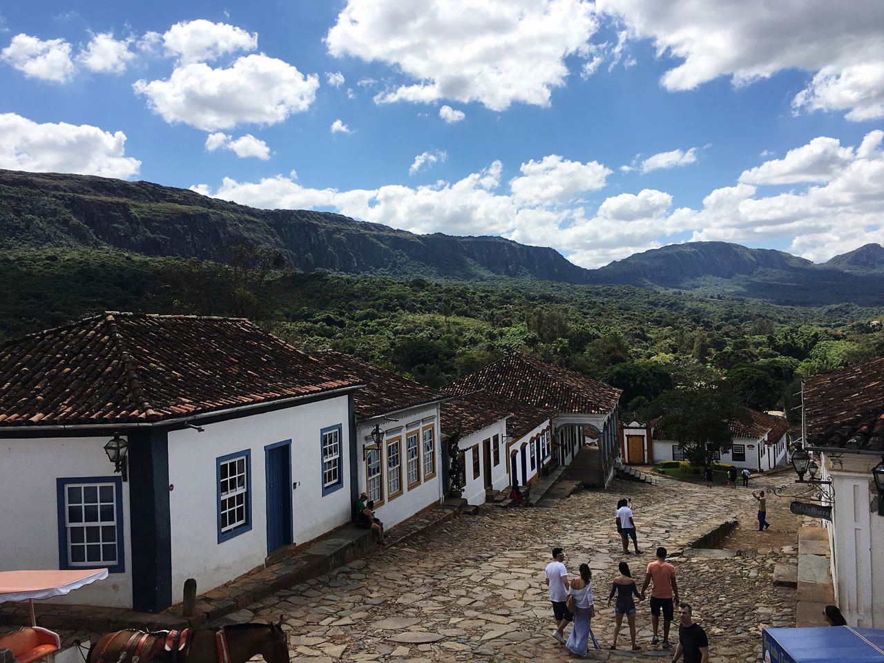 mountain, sky, building exterior, men, lifestyles, architecture, built structure, person, leisure activity, large group of people, mountain range, cloud - sky, cloud, tourist, high angle view, landscape, vacations, tourism, travel destinations