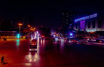 Illuminated city street at night