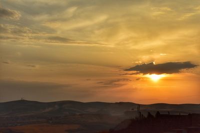 Scenic view of silhouette mountains against sky during sunset