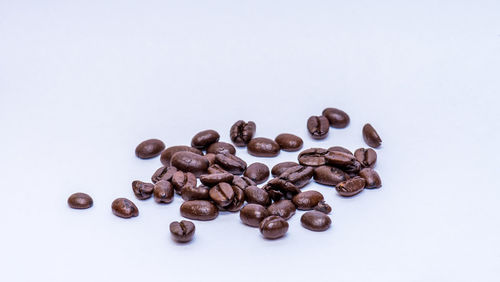 Close-up of coffee beans against white background