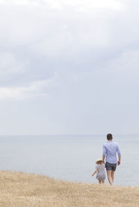 Father with daughter at sea