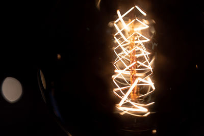 Close-up of illuminated fire in the dark