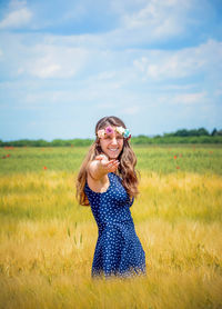 Smiling young woman standing on field