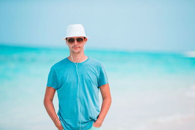 Man standing in sea against sky