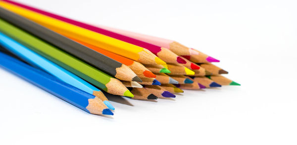 Close-up of multi colored pencils against white background