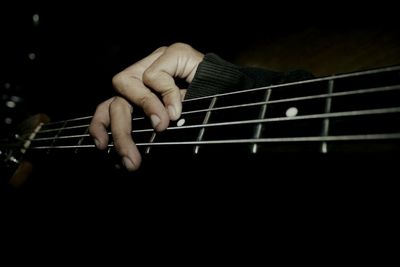 Close-up of hand playing guitar