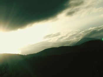 Scenic view of silhouette mountains against sky at sunset