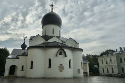 Church by building against sky