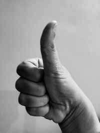 Close-up of human hand against white background