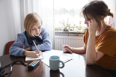 Mother helping daughter with homework