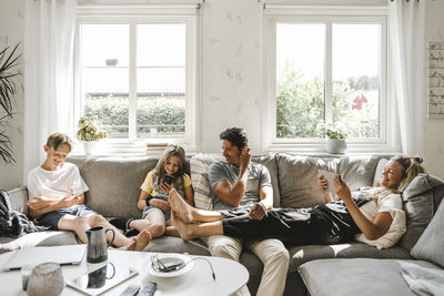 Happy family sitting on sofa in living room