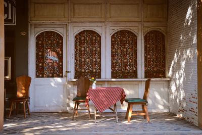 Empty chairs and tables in building