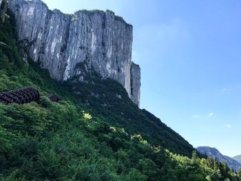 Low angle view of rocks on mountain against sky