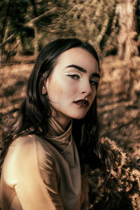 Portrait of young woman with make-up outdoors