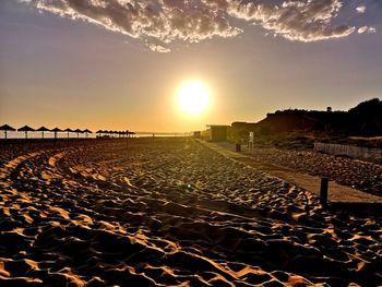 Scenic view of beach against sky during sunset