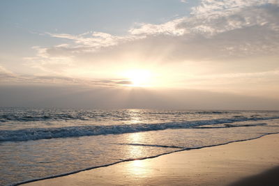 Scenic view of beach against sky during sunset