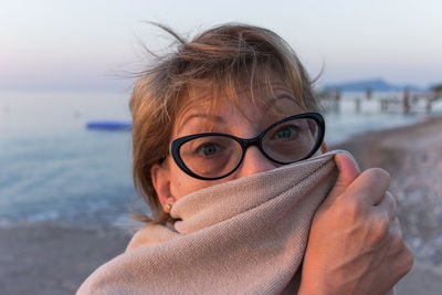 Portrait of woman wearing eyeglasses at beach