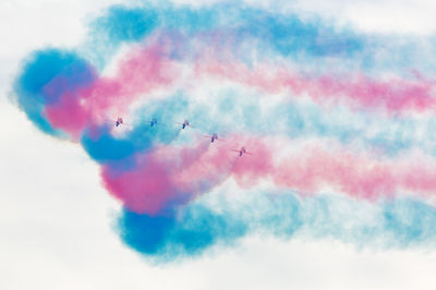 Low angle view of airshow against sky