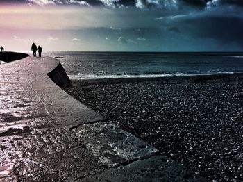 Scenic view of sea against cloudy sky