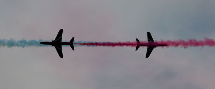 Low angle view of helicopter flying in sky