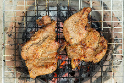 High angle view of meat on barbecue grill