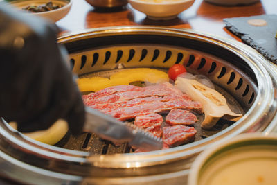 Cropped hand of person preparing food