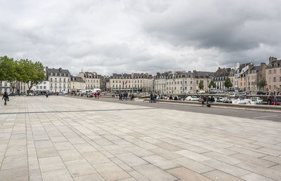 City street by buildings against sky