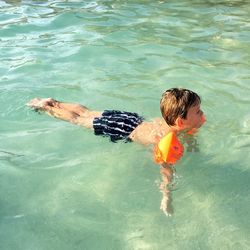 High angle view of boy swimming in pool