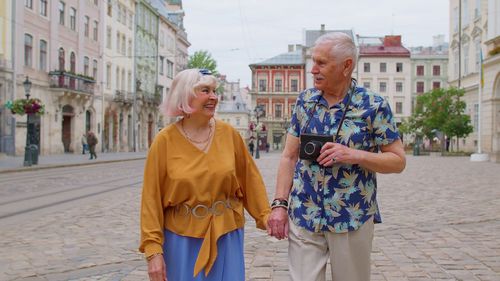 Portrait of smiling friends walking on street