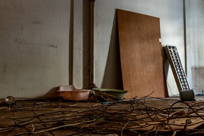 Tables and chairs on table against wall