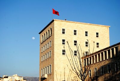 Low angle view of buildings against clear blue sky