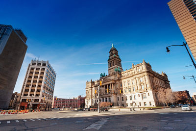 Buildings in city against blue sky