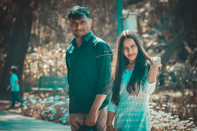 Portrait of young couple standing outdoors