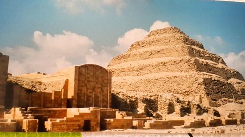 Buildings against cloudy sky