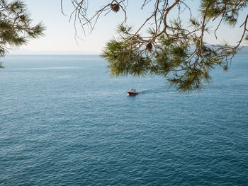 Boat sailing in sea against sky