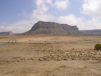 View of desert against cloudy sky