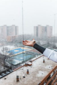 Person hand on glass window in city