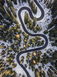 High angle view of winding road from above at sunrise. aerial view of snake road at italy,dolomities
