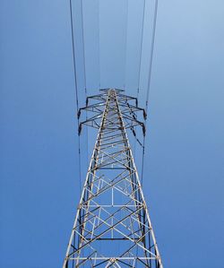 Low angle view of electricity pylon against clear sky