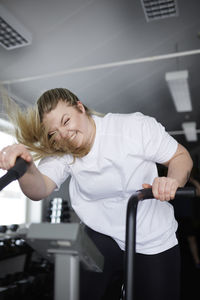 Blond woman exercising in gym