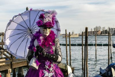 Young woman in sea against sky